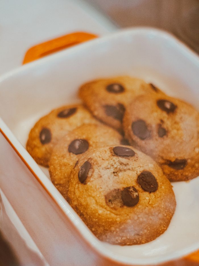 services-01 Close-up of tasty chocolate chip cookies in a baking dish, perfect for dessert lovers.